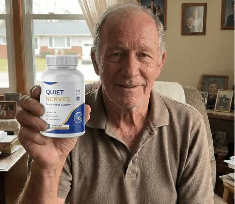 Older man holding a bottle of Quiet Nerves at home