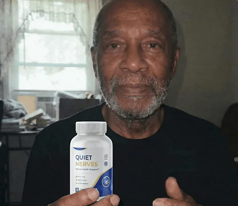 Older man holding a bottle of Quiet Nerves at home